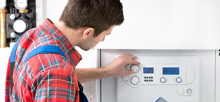 Man adjusting a dial for a central air conditioning system